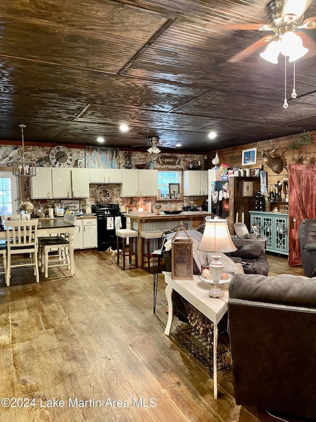 living room featuring light hardwood / wood-style floors, ceiling fan, and wood ceiling