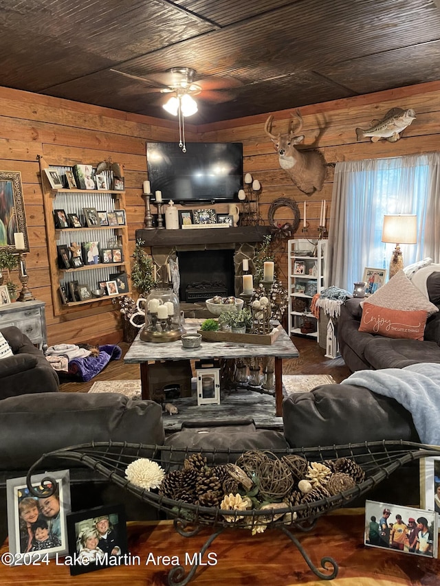 living room featuring ceiling fan, wood ceiling, and wood walls