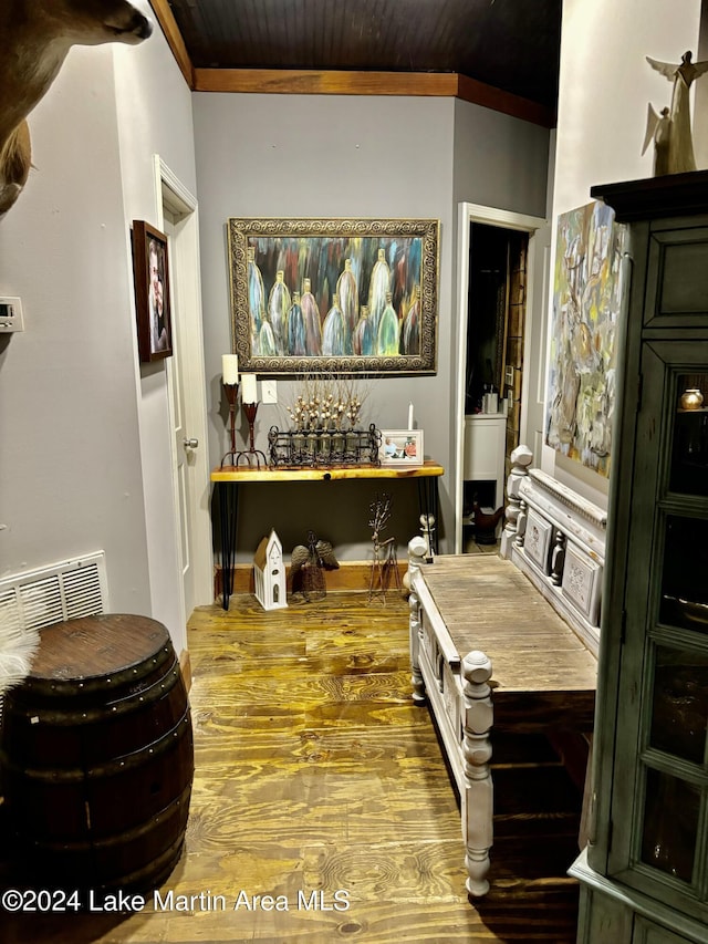 corridor featuring hardwood / wood-style flooring and ornamental molding