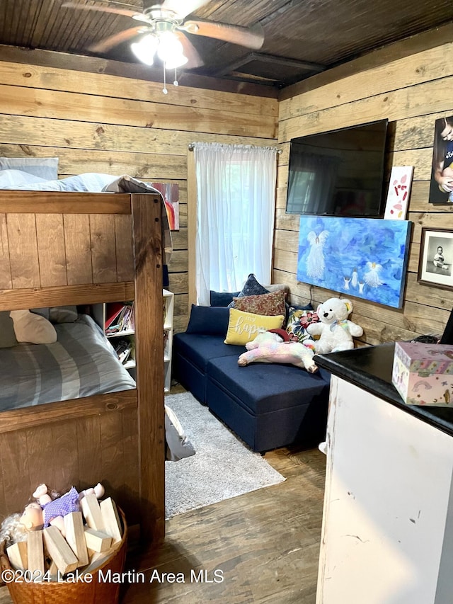 bedroom featuring wooden walls, wood ceiling, and wood-type flooring