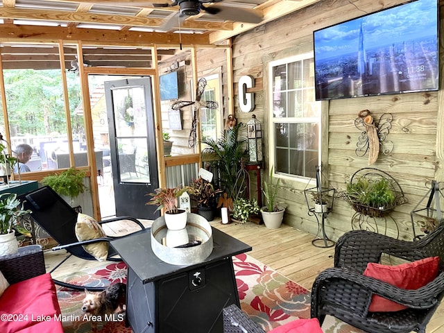 sunroom / solarium featuring ceiling fan