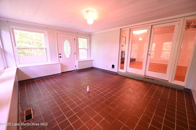 foyer entrance featuring visible vents and baseboards