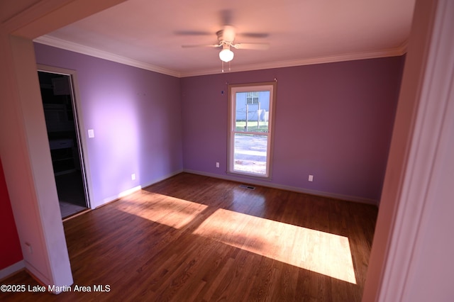 empty room with ceiling fan, baseboards, wood finished floors, and visible vents