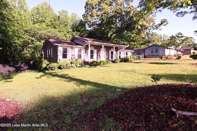 ranch-style house with a front lawn and fence