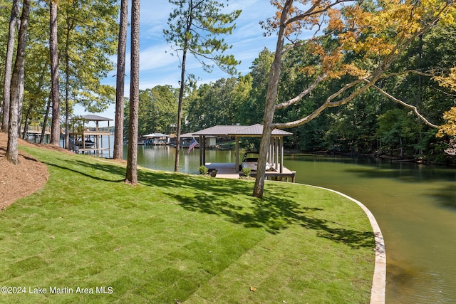 view of yard with a water view and a dock