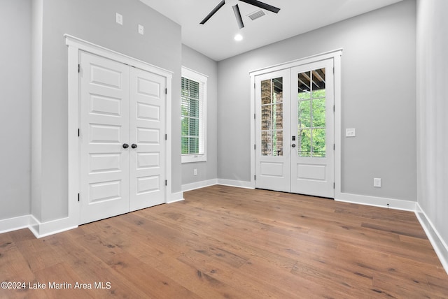 foyer entrance featuring hardwood / wood-style flooring, ceiling fan, and french doors