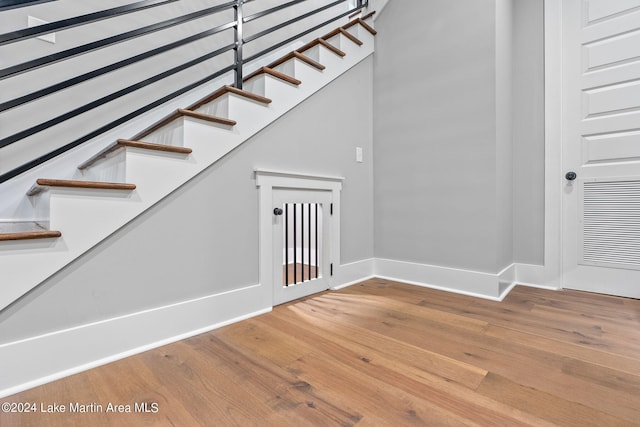 stairs featuring hardwood / wood-style floors