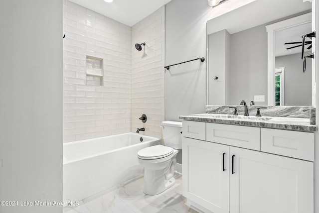 full bathroom featuring vanity, toilet, and tiled shower / bath