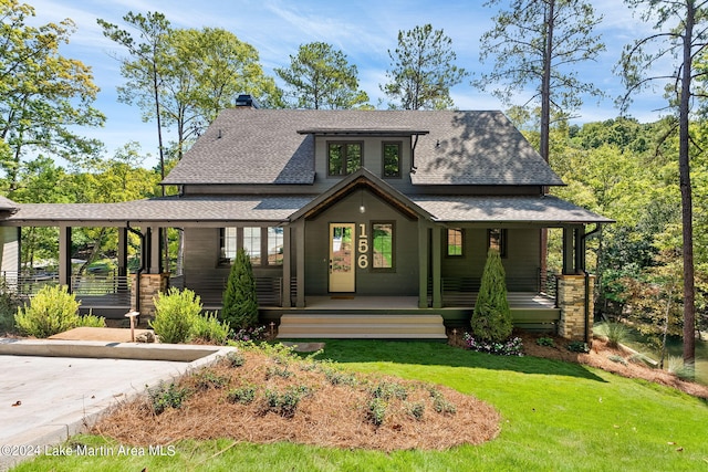 view of front of house featuring covered porch and a front lawn