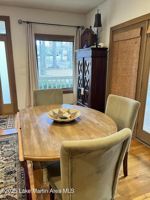 dining space with light hardwood / wood-style flooring