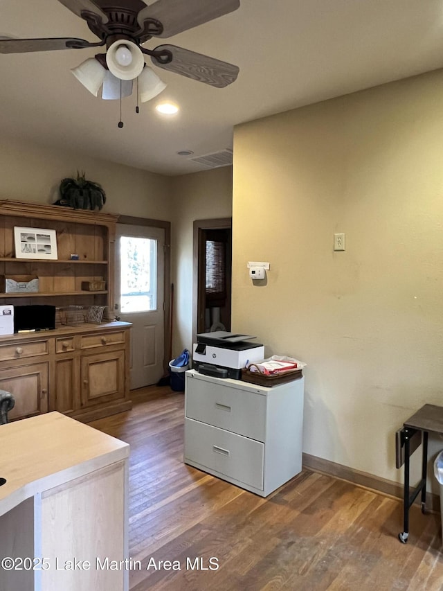 kitchen with ceiling fan and hardwood / wood-style floors