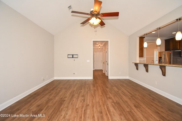 unfurnished living room with ceiling fan, dark hardwood / wood-style flooring, and lofted ceiling