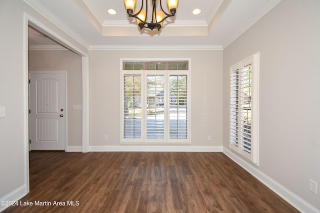 unfurnished room featuring a wealth of natural light, dark hardwood / wood-style flooring, and ornamental molding