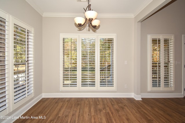 unfurnished dining area featuring a notable chandelier, dark hardwood / wood-style floors, and ornamental molding