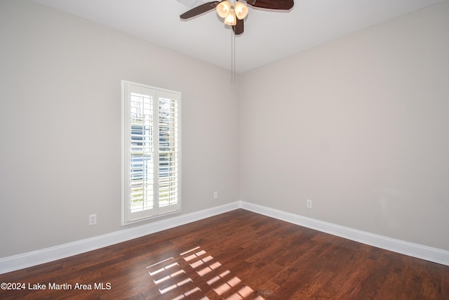 spare room with ceiling fan and dark hardwood / wood-style flooring