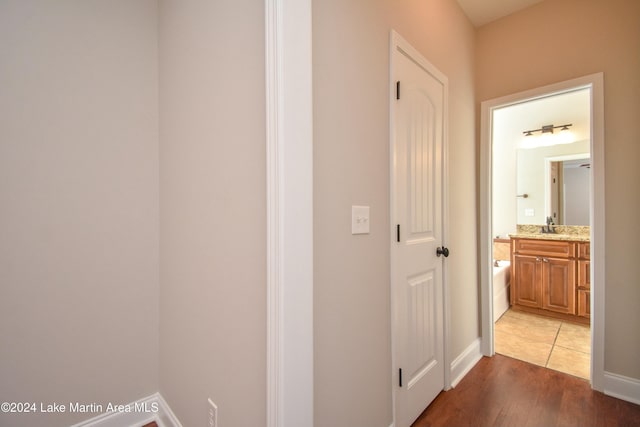 hall featuring hardwood / wood-style floors and sink