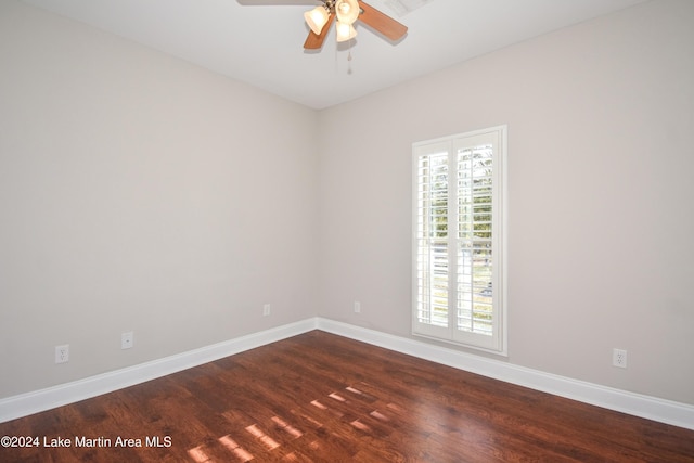 unfurnished room featuring ceiling fan, dark hardwood / wood-style flooring, and a healthy amount of sunlight