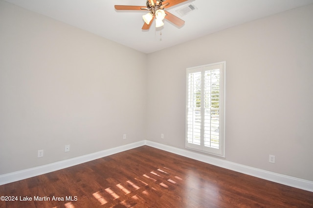 empty room with dark hardwood / wood-style floors and ceiling fan