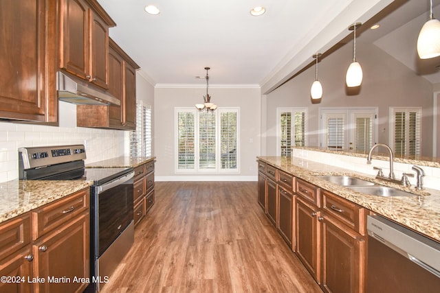 kitchen with appliances with stainless steel finishes, ornamental molding, sink, light hardwood / wood-style flooring, and hanging light fixtures