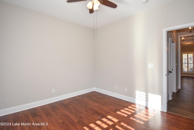 empty room featuring ceiling fan and dark wood-type flooring