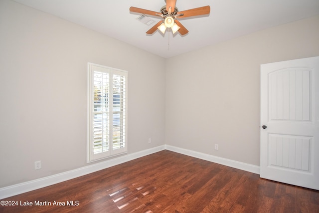 unfurnished room with ceiling fan and dark hardwood / wood-style floors