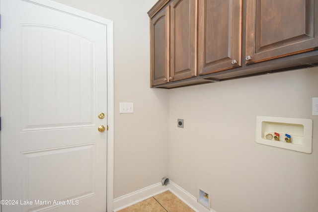 laundry room with washer hookup, hookup for an electric dryer, cabinets, and light tile patterned floors