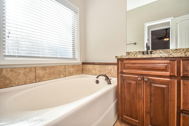 bathroom featuring a bathing tub, ceiling fan, and vanity