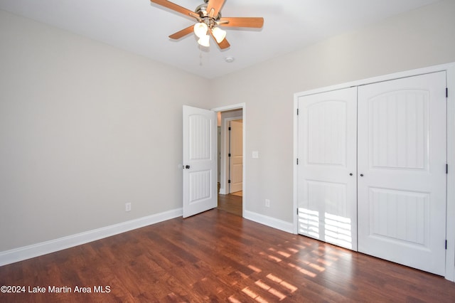 unfurnished bedroom with a closet, ceiling fan, and dark hardwood / wood-style flooring