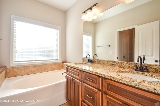 bathroom with vanity and a bath