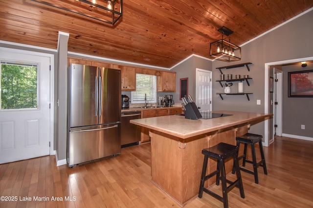 838 Bama Park Rd, Dadeville, AL 36853 - kitchen with appliances with stainless steel finishes, wooden ceiling, ornamental molding, brown cabinetry, and a sink