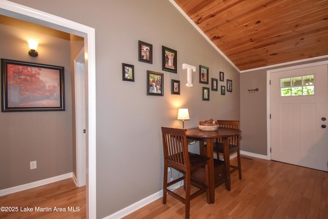838 Bama Park Rd, Dadeville, AL 36853 - dining room with wooden ceiling, vaulted ceiling, light wood-style flooring, and baseboards