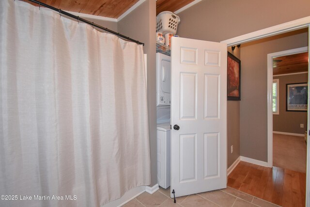 838 Bama Park Rd, Dadeville, AL 36853 - bathroom featuring stacked washer and clothes dryer, baseboards, and tile patterned flooring
