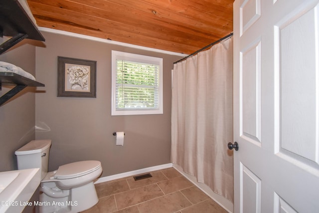 838 Bama Park Rd, Dadeville, AL 36853 - full bathroom with wood ceiling, toilet, tile patterned flooring, baseboards, and curtained shower