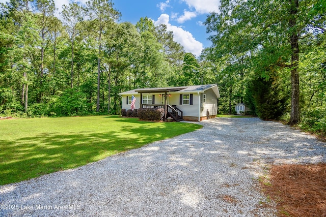 838 Bama Park Rd, Dadeville, AL 36853 - view of front of house with gravel driveway, a front lawn, a storage shed, and an outdoor structure