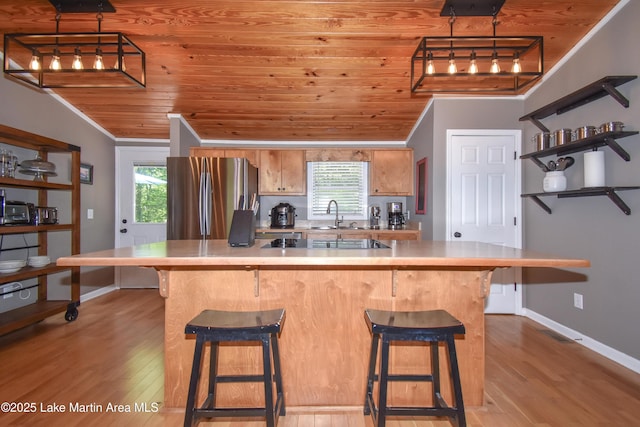 838 Bama Park Rd, Dadeville, AL 36853 - kitchen featuring freestanding refrigerator, wooden ceiling, ornamental molding, wood finished floors, and light countertops