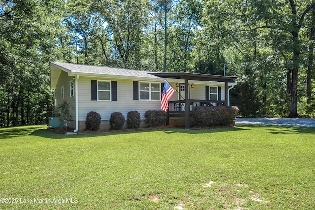 838 Bama Park Rd, Dadeville, AL 36853 - view of front of house with covered porch, a front lawn, view of scattered trees, and roof with shingles