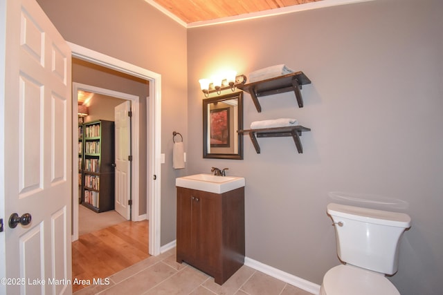 838 Bama Park Rd, Dadeville, AL 36853 - bathroom with toilet, vanity, baseboards, and wood finished floors