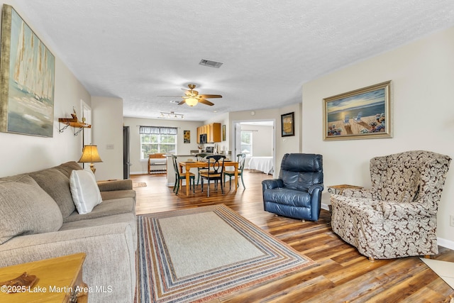 741 Lakeview Rdg, Dadeville, AL 36853 - living area featuring wood finished floors, ceiling fan, and a textured ceiling