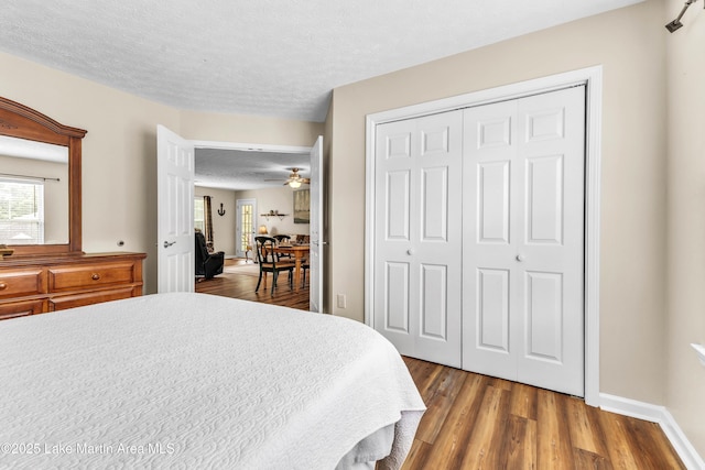 741 Lakeview Rdg, Dadeville, AL 36853 - bedroom with multiple windows, wood finished floors, a closet, and a textured ceiling