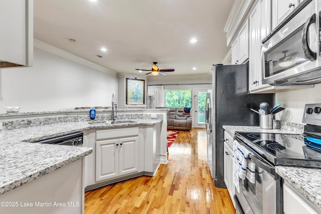 64 Stoneview Summit Ct Unit 5206, Dadeville, AL 36853 - kitchen featuring appliances with stainless steel finishes, ornamental molding, white cabinets, light wood-style flooring, and open floor plan