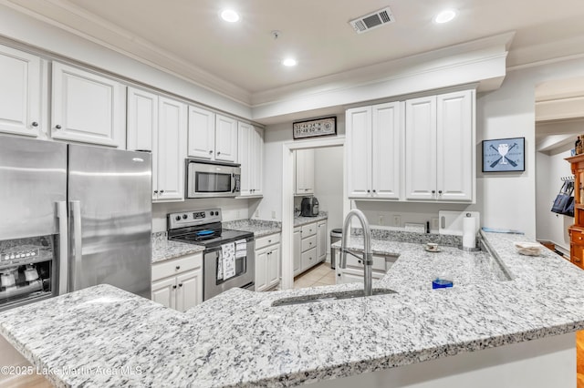 64 Stoneview Summit Ct Unit 5206, Dadeville, AL 36853 - kitchen featuring appliances with stainless steel finishes, ornamental molding, a peninsula, light stone counters, and recessed lighting