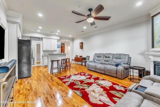 64 Stoneview Summit Ct Unit 5206, Dadeville, AL 36853 - living room with light wood-type flooring, a ceiling fan, ornamental molding, recessed lighting, and a fireplace
