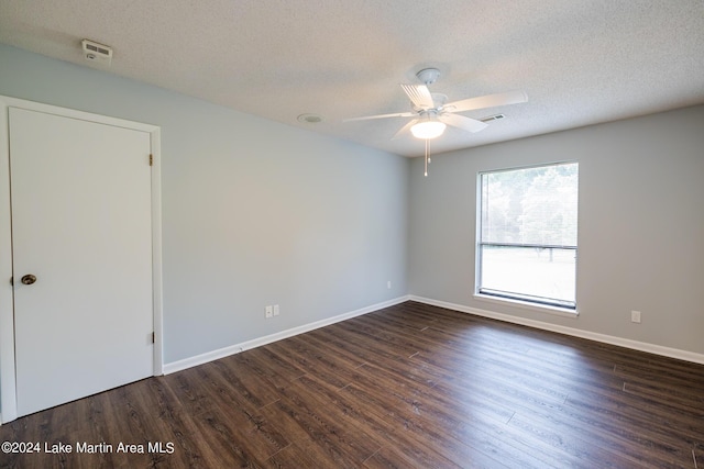 unfurnished room featuring ceiling fan, dark hardwood / wood-style floors, and a textured ceiling