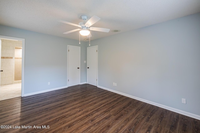 spare room with dark hardwood / wood-style flooring and ceiling fan