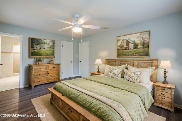 bedroom with ceiling fan, connected bathroom, and dark hardwood / wood-style flooring