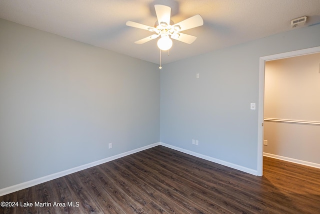 unfurnished room with dark hardwood / wood-style floors and ceiling fan