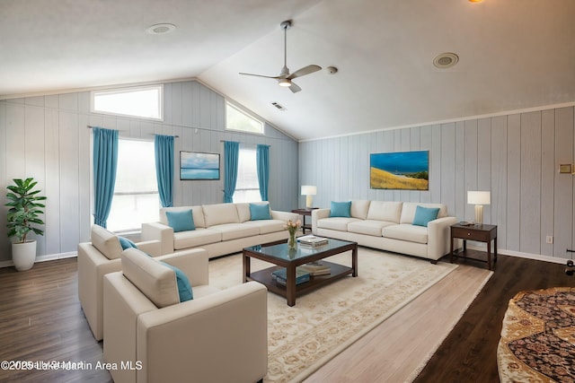 living room with hardwood / wood-style flooring, ceiling fan, and vaulted ceiling