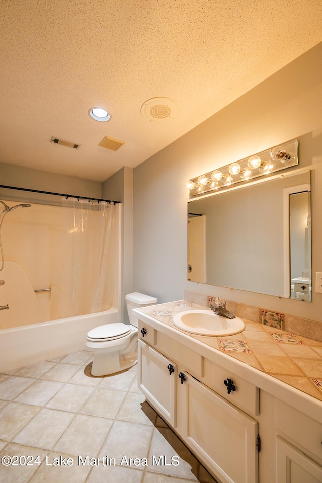 full bathroom featuring vanity, shower / tub combo, toilet, tile patterned floors, and a textured ceiling