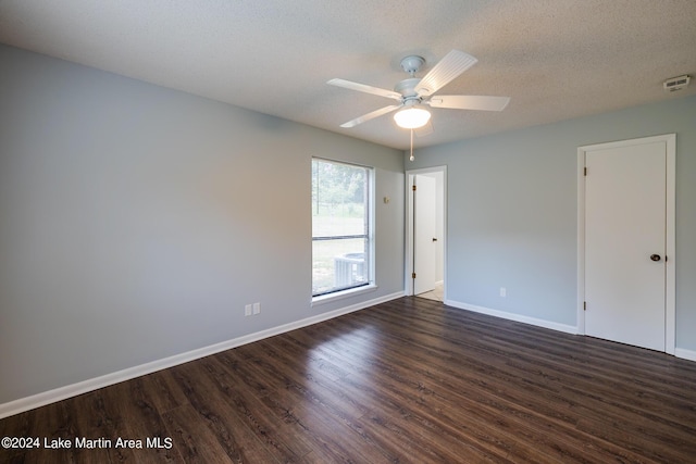 unfurnished room featuring ceiling fan, dark wood-type flooring, and a textured ceiling