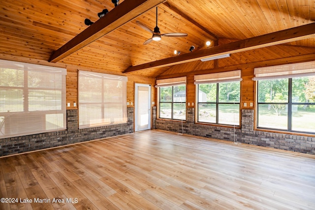 unfurnished living room featuring hardwood / wood-style floors, wood ceiling, vaulted ceiling with beams, and brick wall